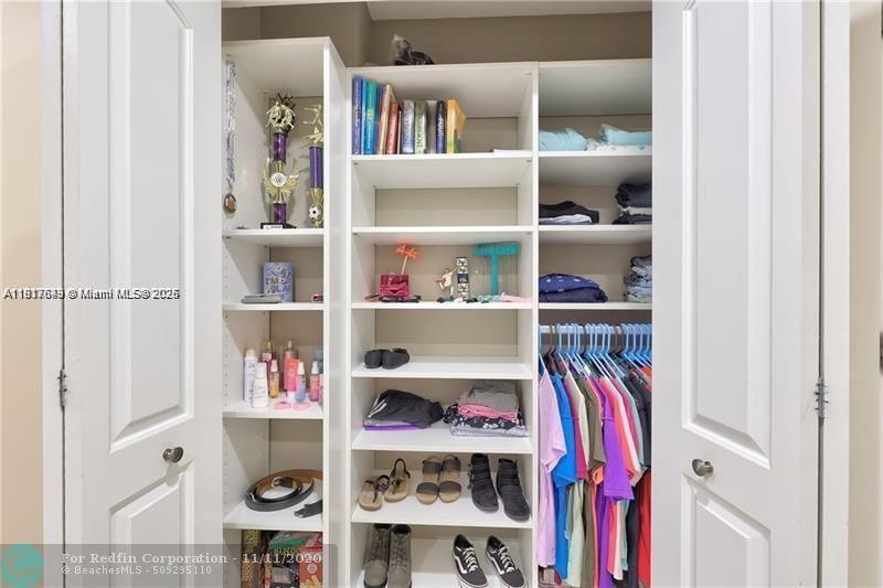 3100 Riverside Drive, Unit 107 Coral Springs, FL 33065 - Photo 25 of 33 a view of walk in closet with clothes and shoes