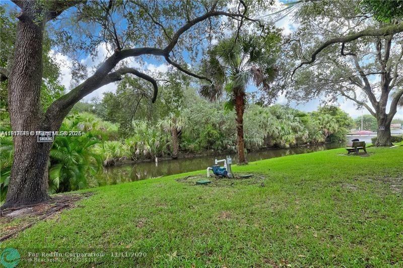 3100 Riverside Drive, Unit 107 Coral Springs, FL 33065 - Photo 31 of 33 a view of a garden with a tree