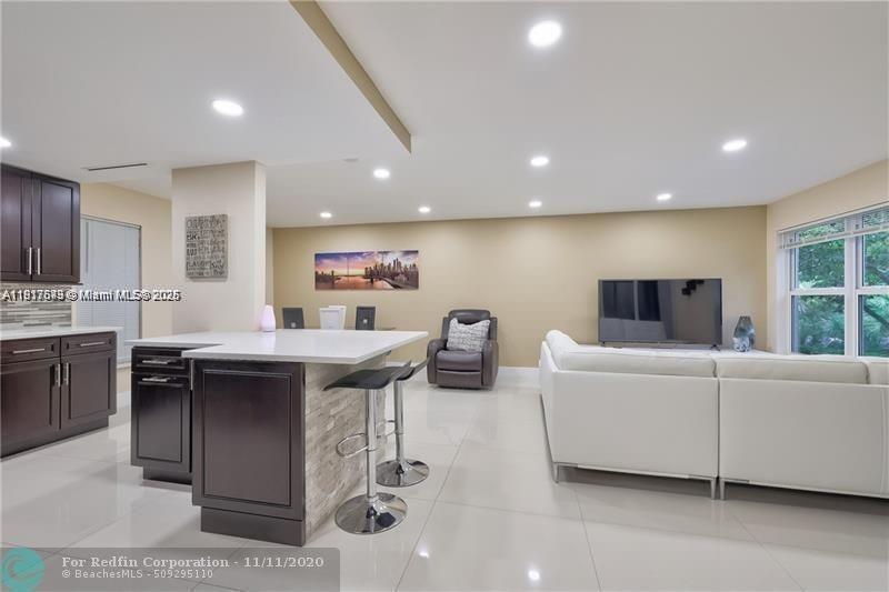 3100 Riverside Drive, Unit 107 Coral Springs, FL 33065 - Photo 5 of 33 a living room with furniture and a flat screen tv