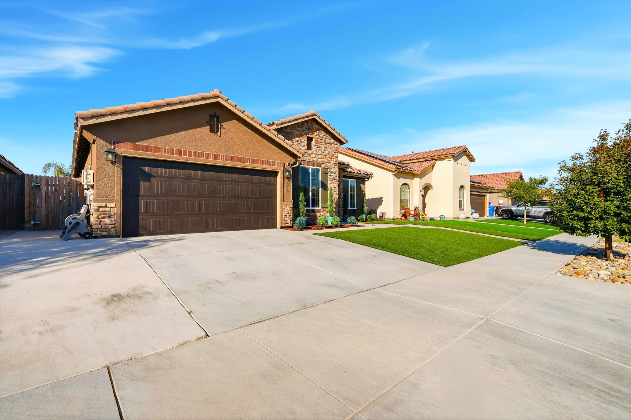 756 Strada Street Lemoore, CA 93245 - Photo 41 of 53 a front view of a house with a yard and garage