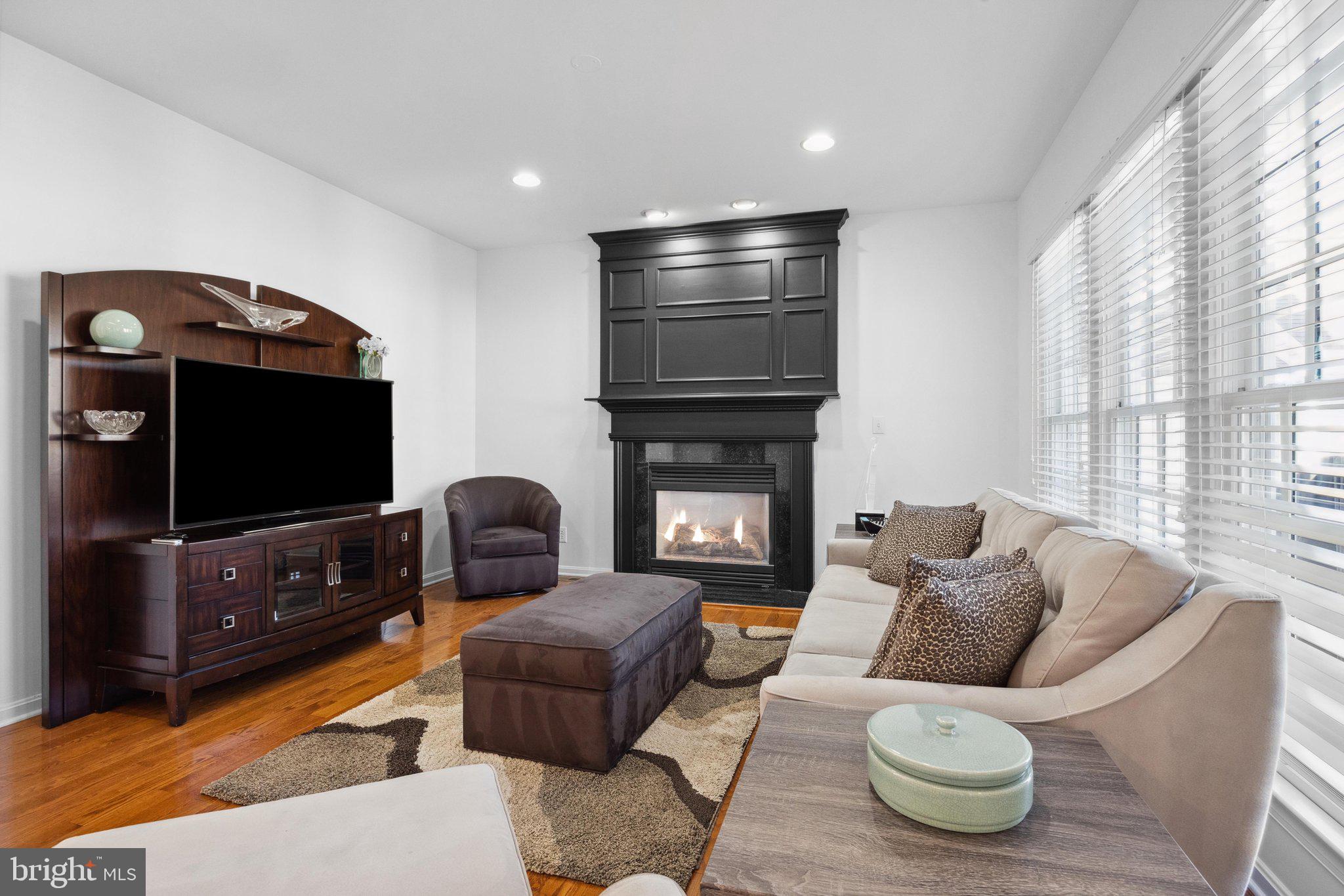 1615 Silver Birch Road Huntingdon Valley, PA 19006 - Photo 11 of 69 a living room with furniture a flat screen tv and a fireplace