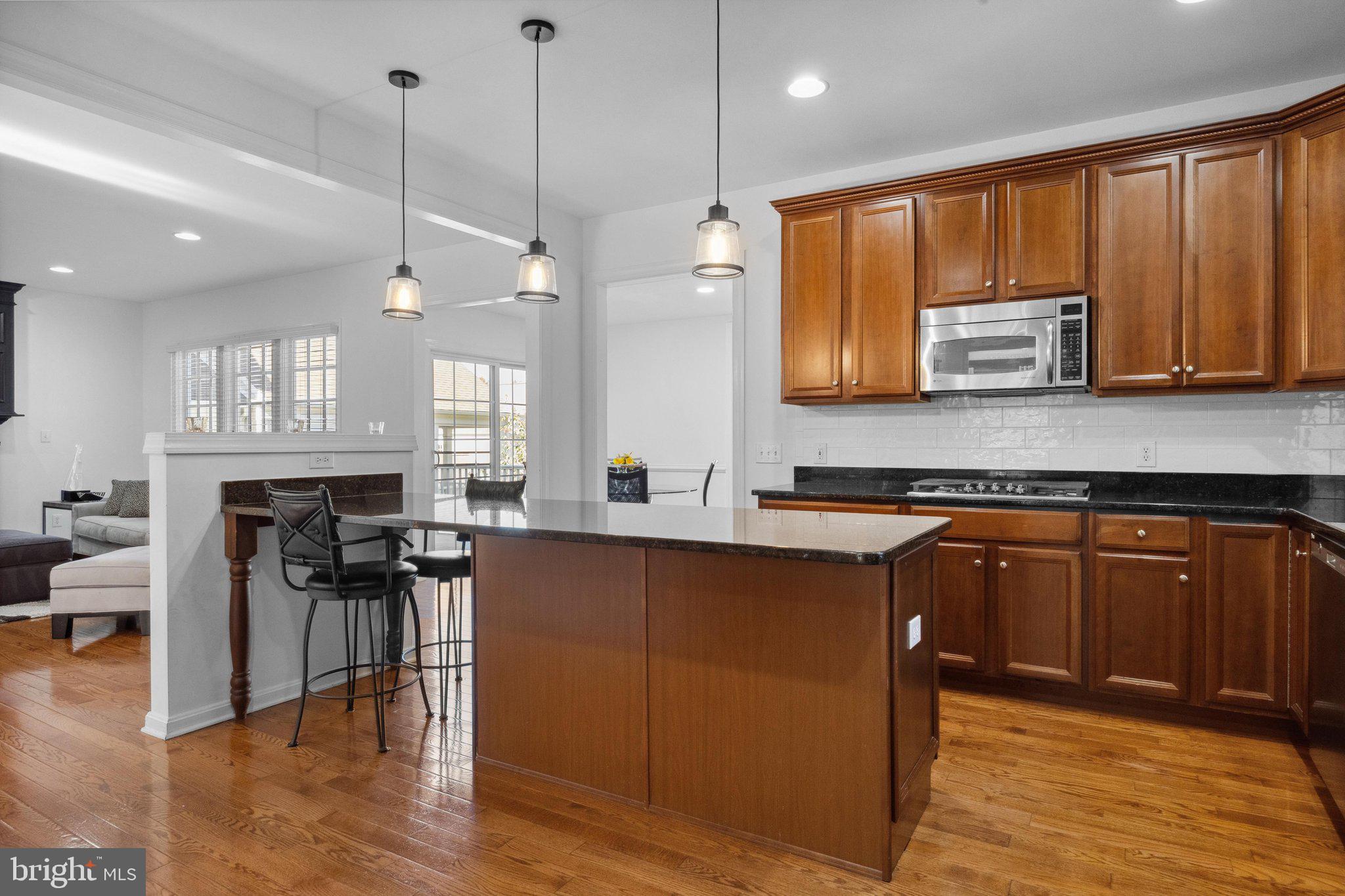1615 Silver Birch Road Huntingdon Valley, PA 19006 - Photo 17 of 69 a kitchen with stainless steel appliances granite countertop wooden cabinets a stove a sink and a large window