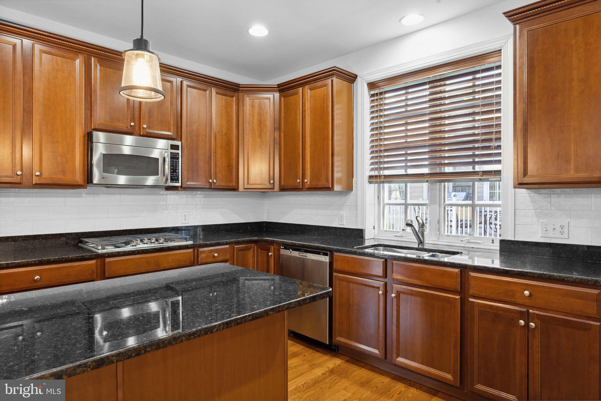 1615 Silver Birch Road Huntingdon Valley, PA 19006 - Photo 18 of 69 a kitchen with granite countertop stainless steel appliances a sink a stove window and cabinets