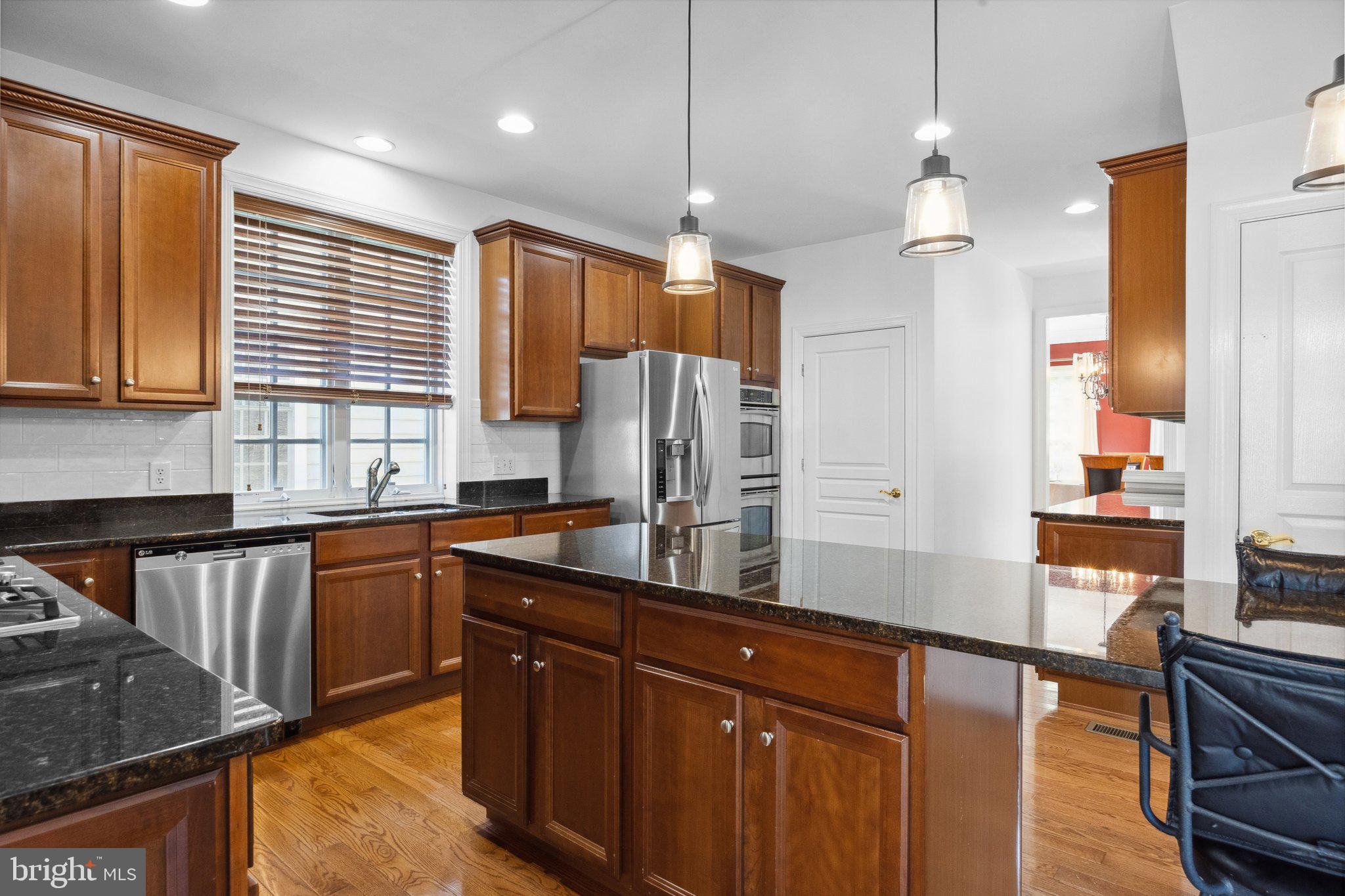 1615 Silver Birch Road Huntingdon Valley, PA 19006 - Photo 19 of 69 a kitchen with stainless steel appliances granite countertop sink stove refrigerator and cabinets