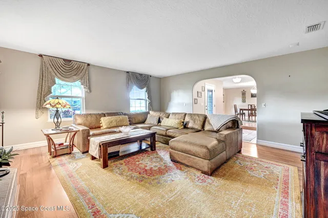 a bed room with a bed a television and a couch