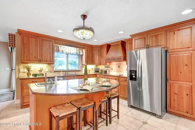 a kitchen with a stove a refrigerator and a dining table