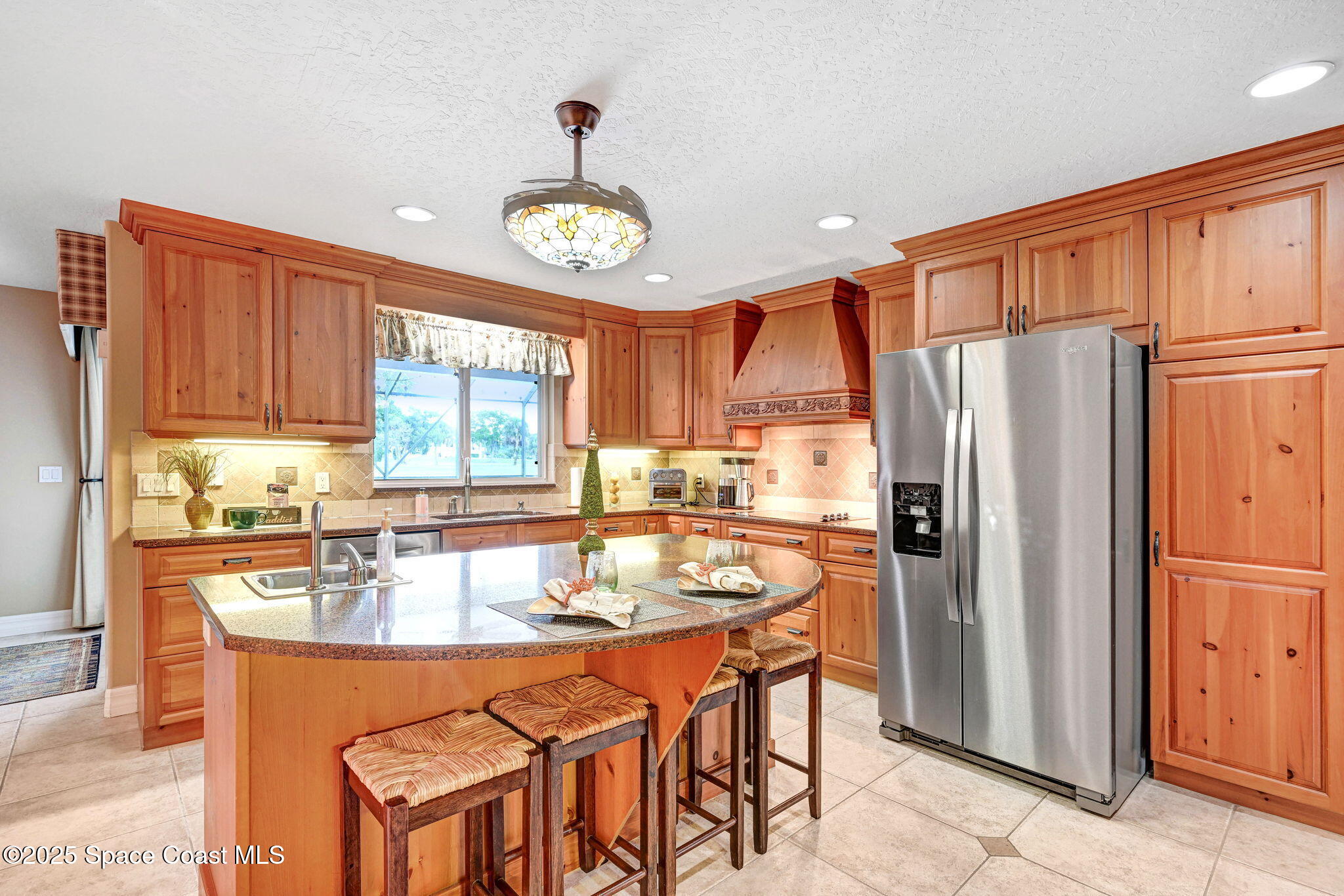 1428 Gleneagles Way Rockledge, FL 32955 - Photo 15 of 90 a kitchen with stainless steel appliances granite countertop a refrigerator and a stove top oven
