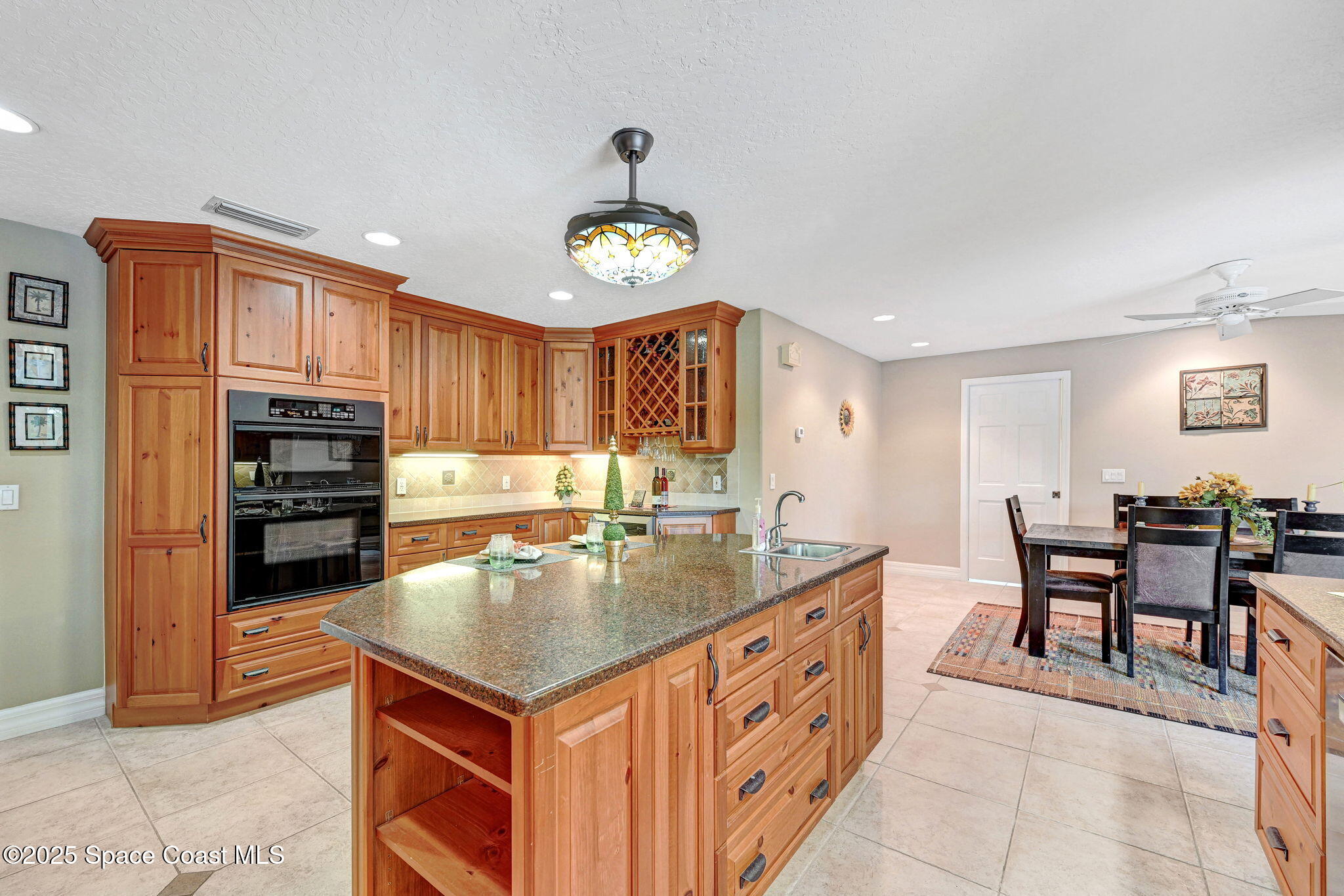 1428 Gleneagles Way Rockledge, FL 32955 - Photo 17 of 90 a kitchen with a stove a refrigerator and a dining table