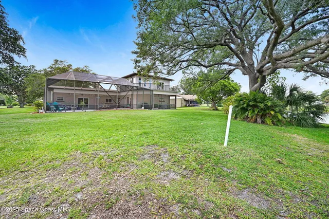 a view of a hallway with wooden floor and stairs