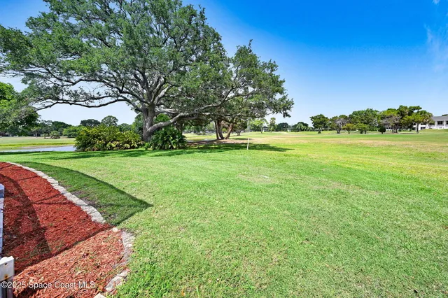 a view of a balcony with yard
