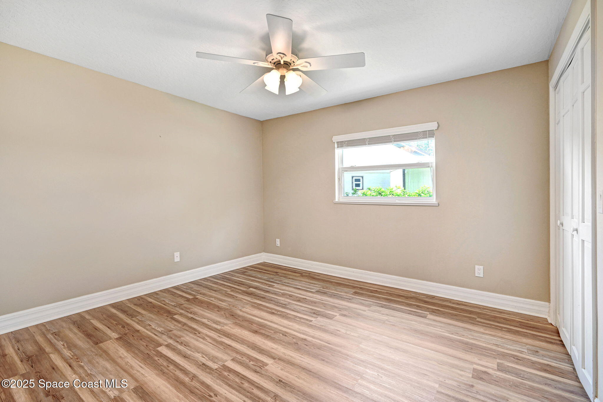 1428 Gleneagles Way Rockledge, FL 32955 - Photo 26 of 90 wooden floor in an empty room with a window