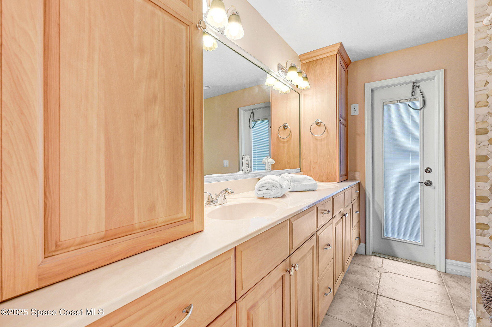 1428 Gleneagles Way Rockledge, FL 32955 - Photo 28 of 90 a bathroom with a sink and a mirror