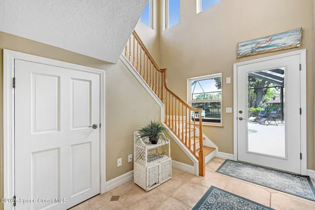 an aerial view of a house with a yard and lake view in back