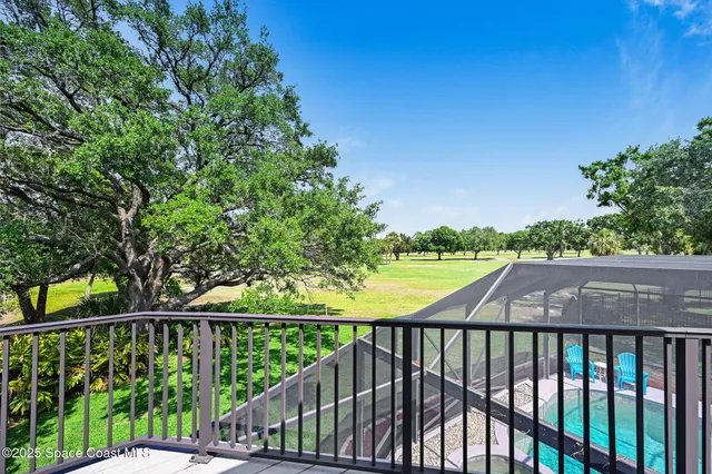 an aerial view of a pool yard and mountain view in back