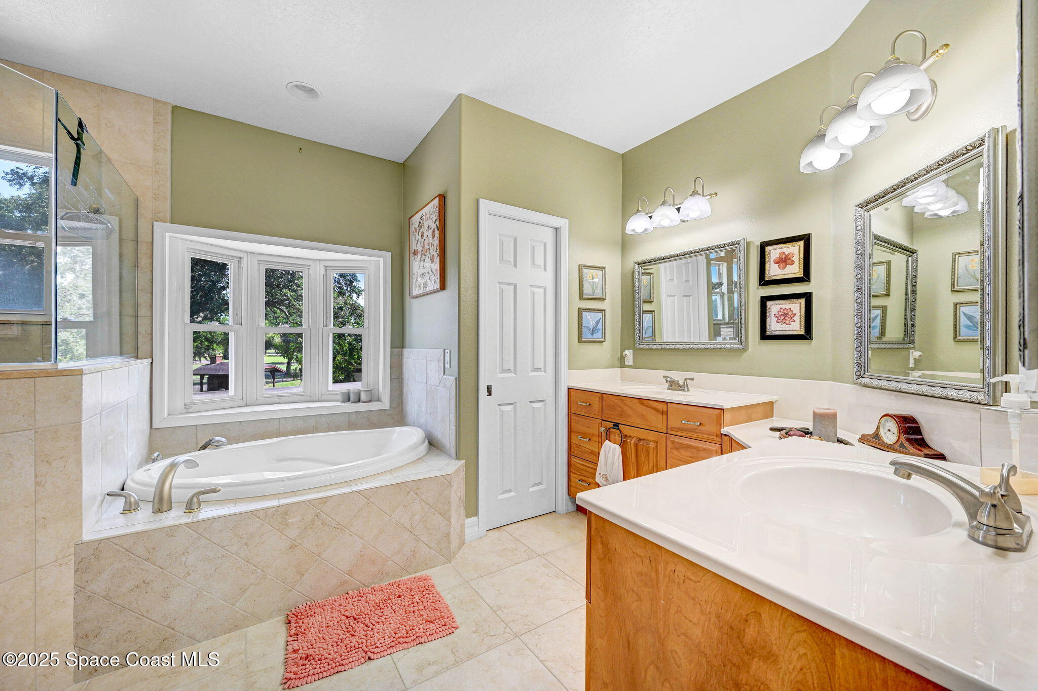 1428 Gleneagles Way Rockledge, FL 32955 - Photo 51 of 90 a spacious bathroom with a tub sink and mirror