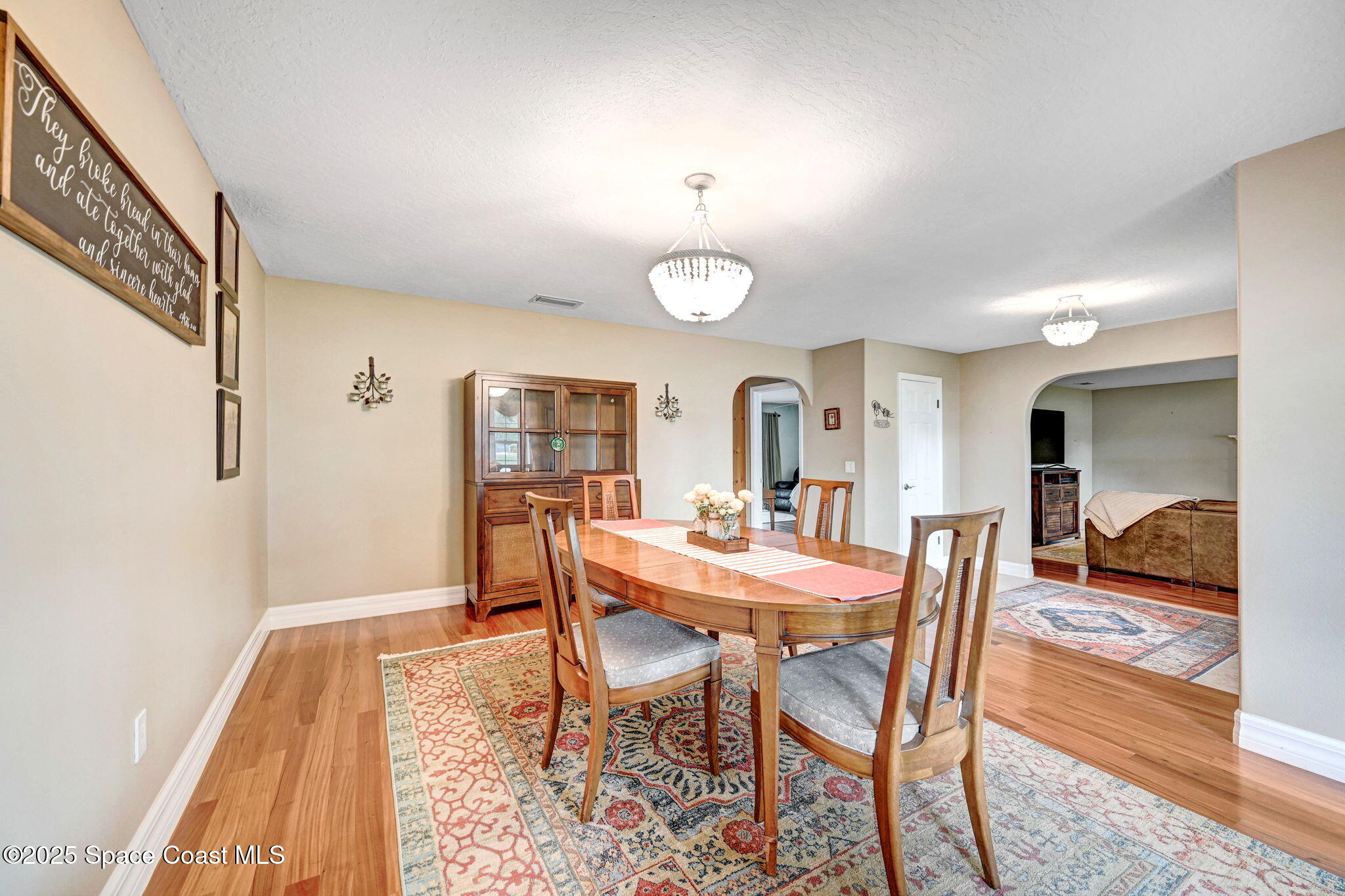 1428 Gleneagles Way Rockledge, FL 32955 - Photo 7 of 90 a view of a dining room with furniture and wooden floor