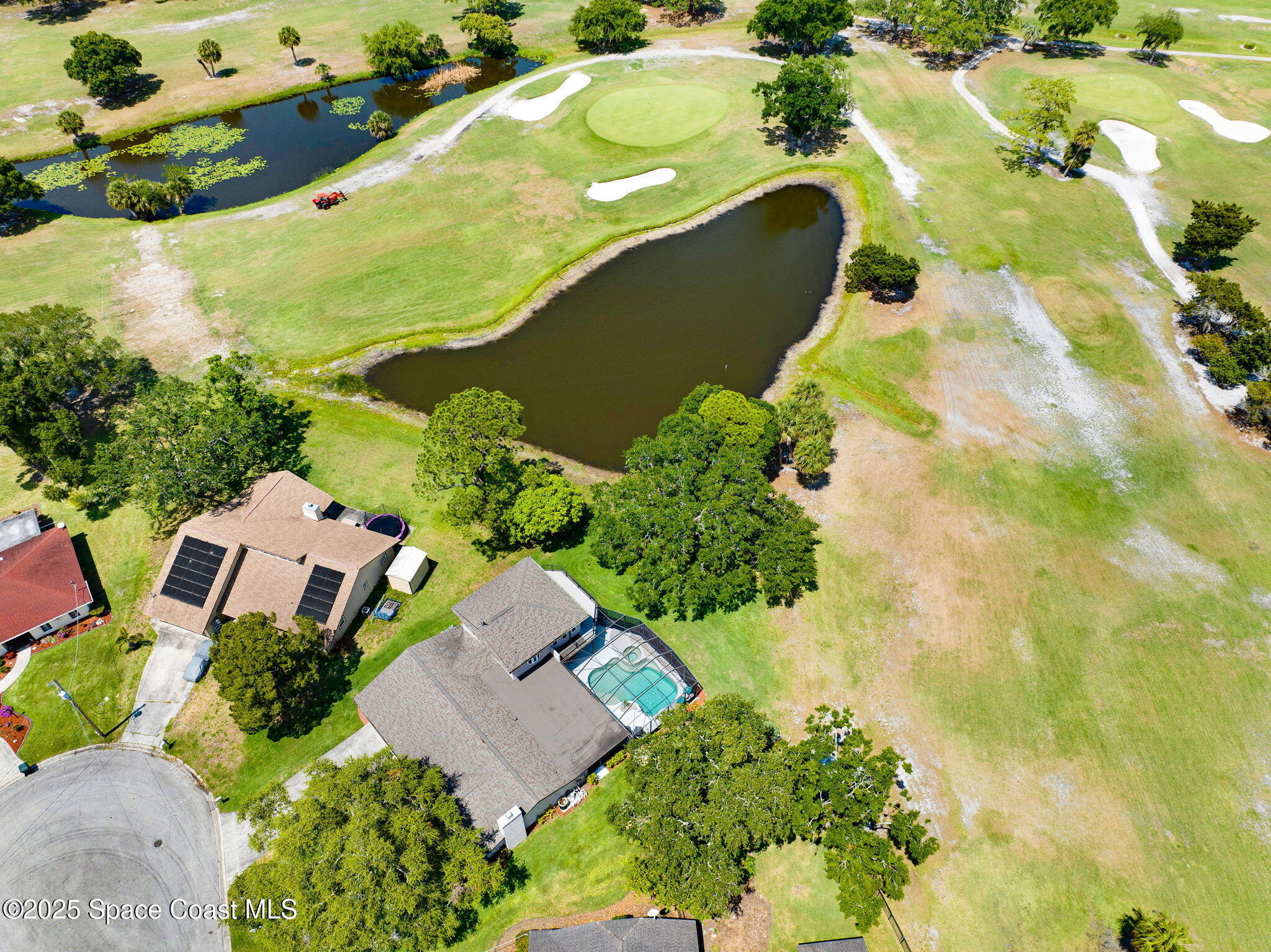 1428 Gleneagles Way Rockledge, FL 32955 - Photo 74 of 90 an aerial view of a house with a yard and lake view in back