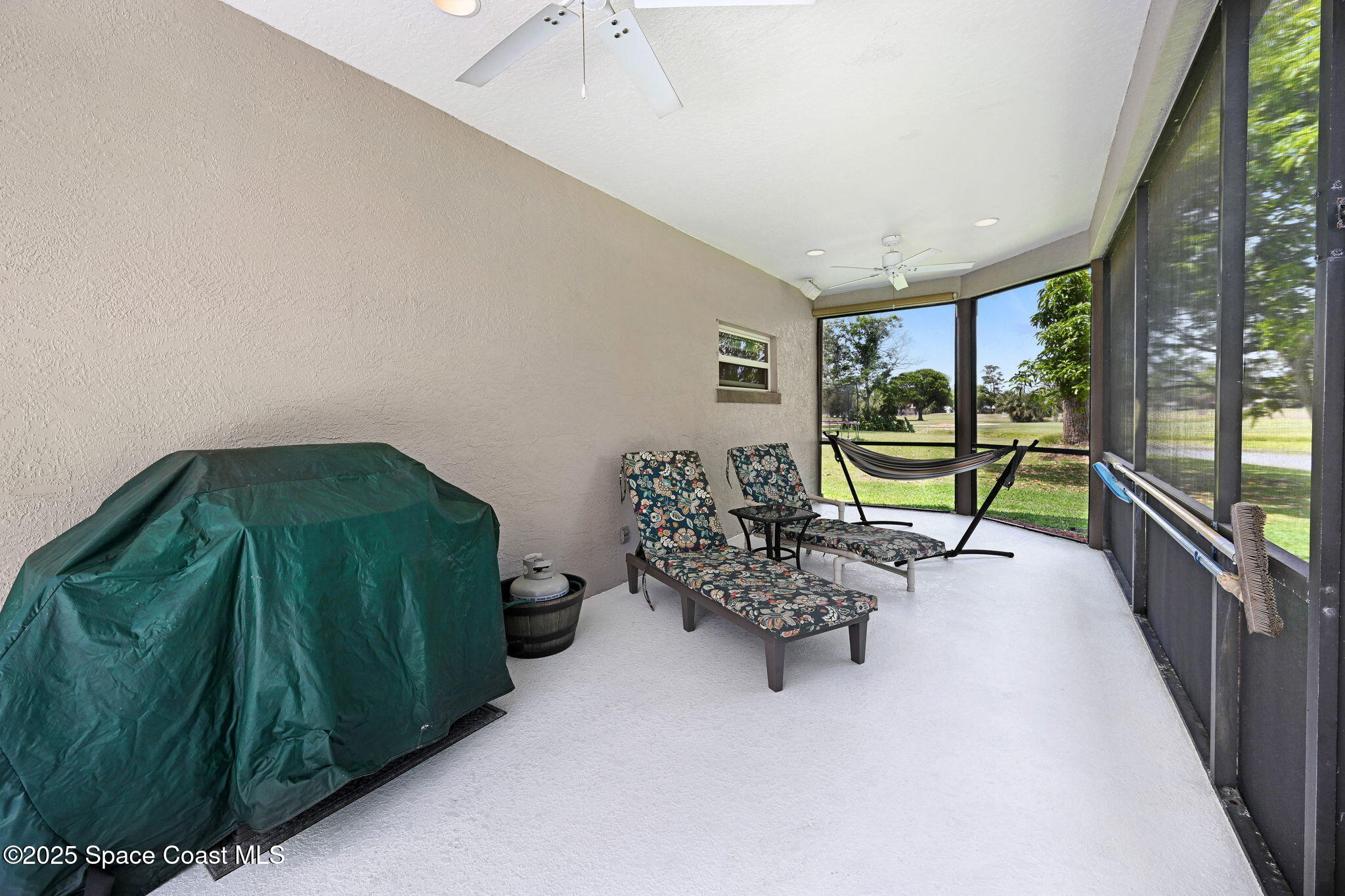 1428 Gleneagles Way Rockledge, FL 32955 - Photo 82 of 90 a living room with furniture and a large window