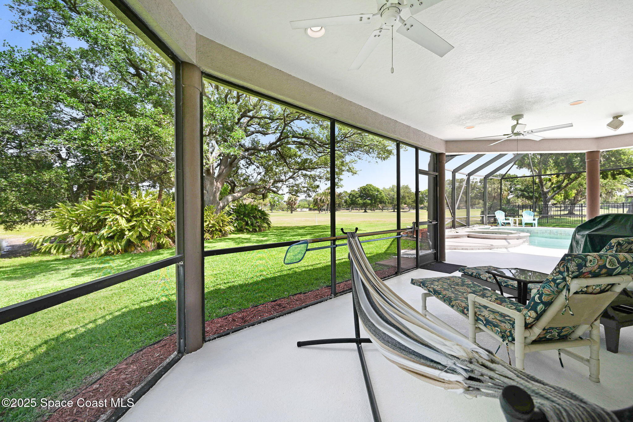 1428 Gleneagles Way Rockledge, FL 32955 - Photo 84 of 90 a view of a patio with a table chairs and a yard