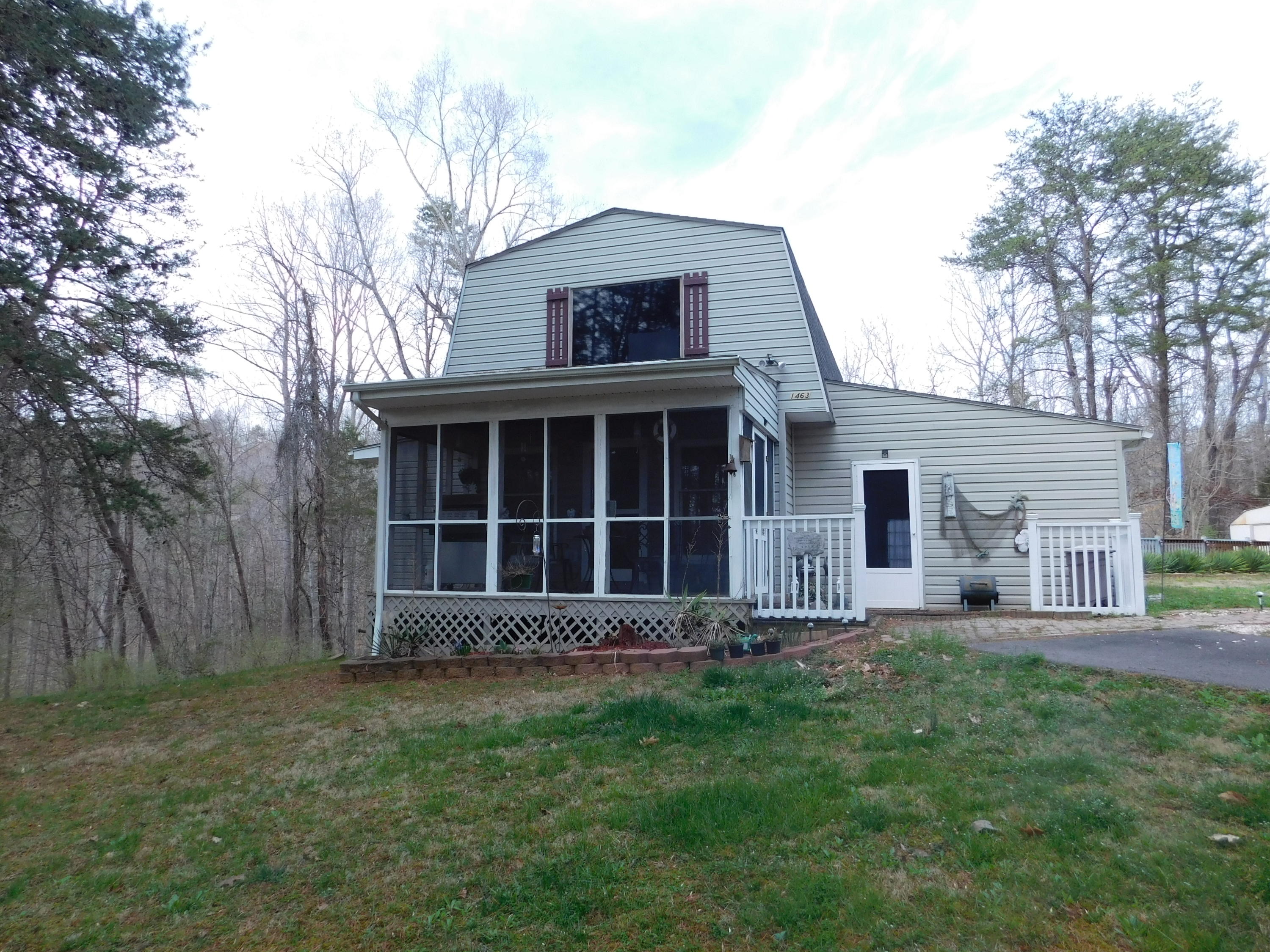 1463 Stripers Cove Road Goodview, VA 24095 - Photo 2 of 44 a front view of a house with a yard