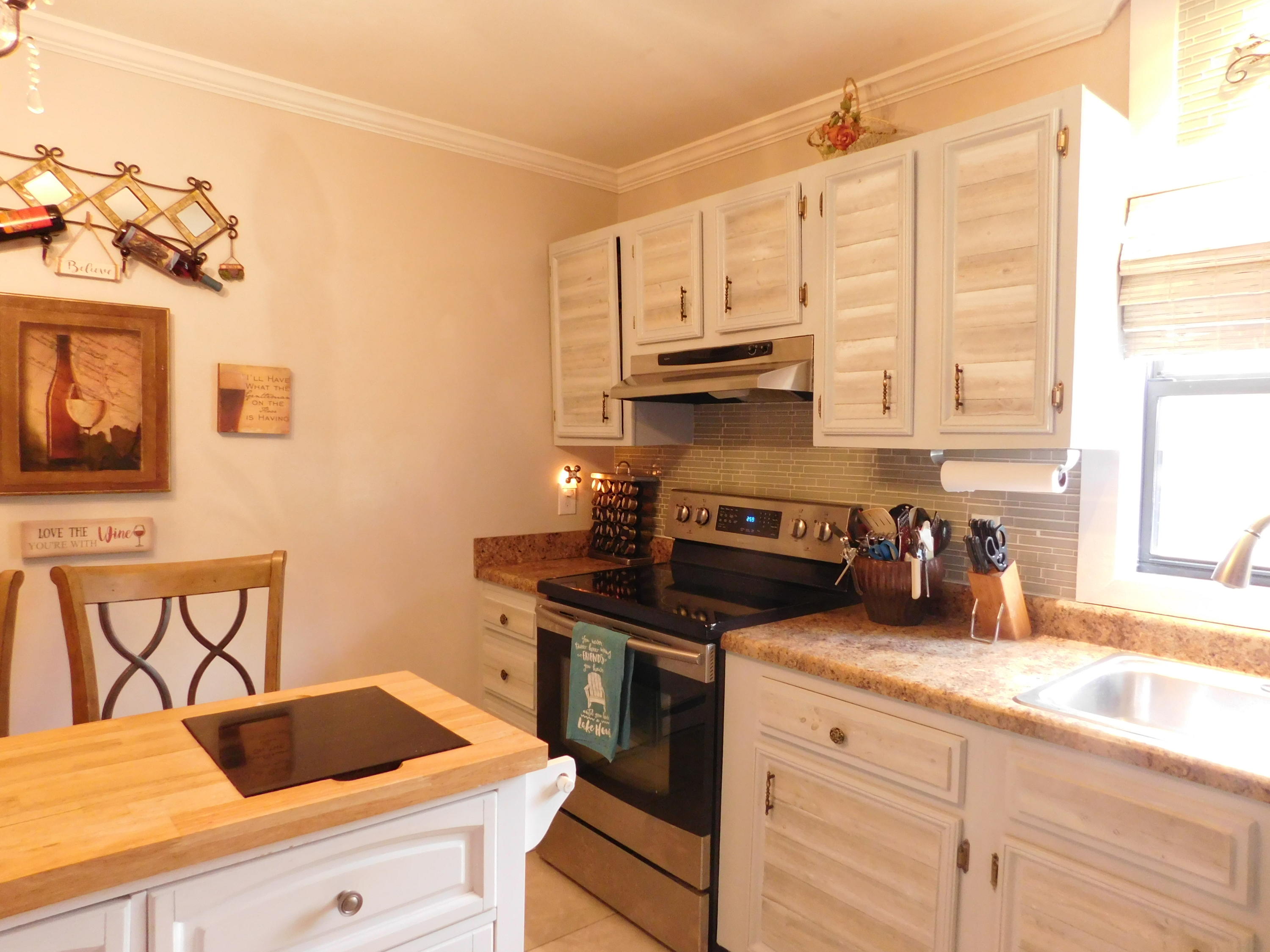 1463 Stripers Cove Road Goodview, VA 24095 - Photo 12 of 44 a kitchen with stainless steel appliances a sink a stove and cabinets