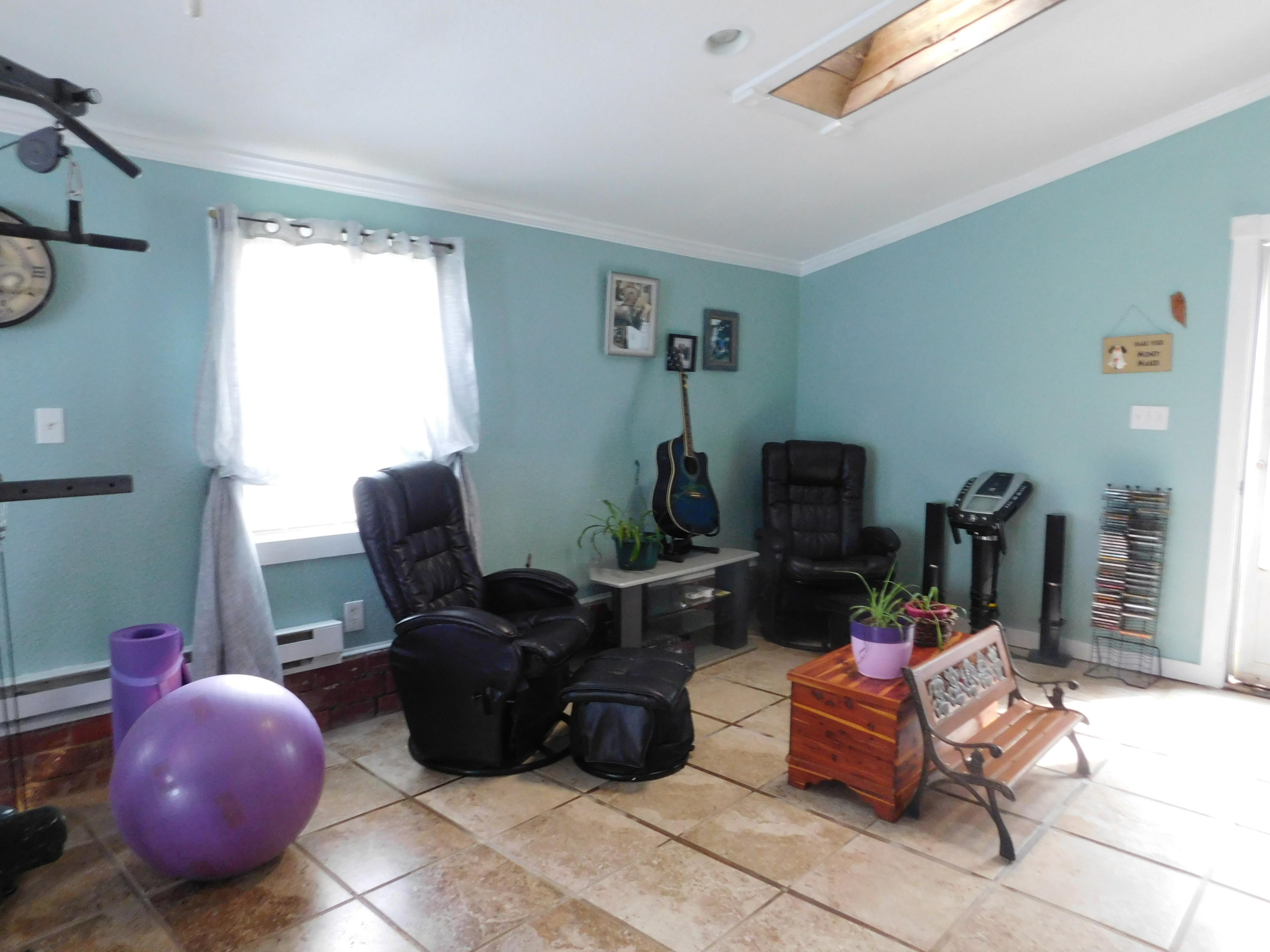 1463 Stripers Cove Road Goodview, VA 24095 - Photo 19 of 44 a living room with furniture and a wooden floor