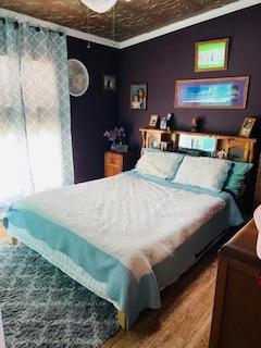 1463 Stripers Cove Road Goodview, VA 24095 - Photo 29 of 44 a bed sitting in a bedroom next to a lamp