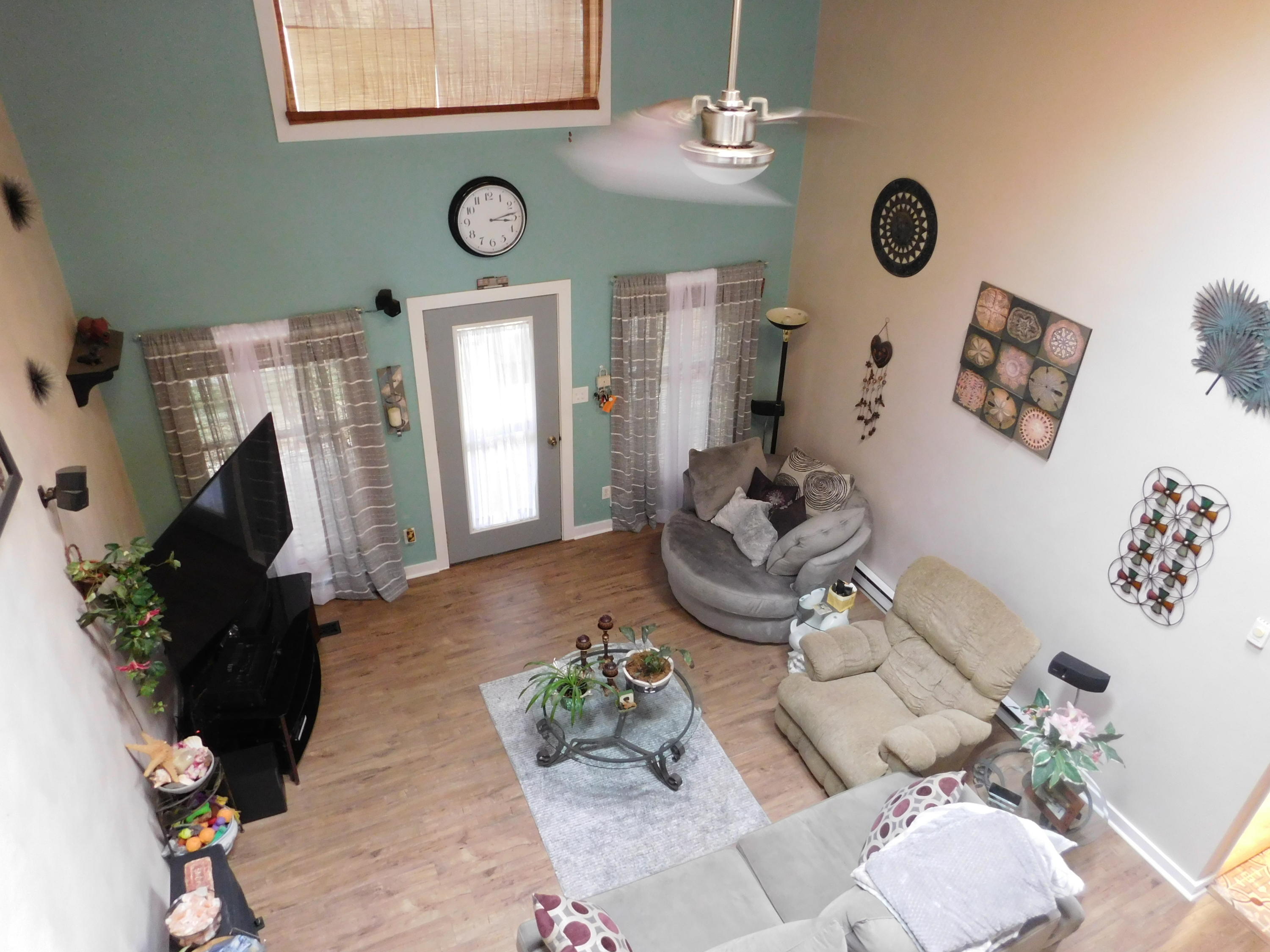 1463 Stripers Cove Road Goodview, VA 24095 - Photo 35 of 44 a view of a livingroom and dining room with furniture wooden floor and a chandelier