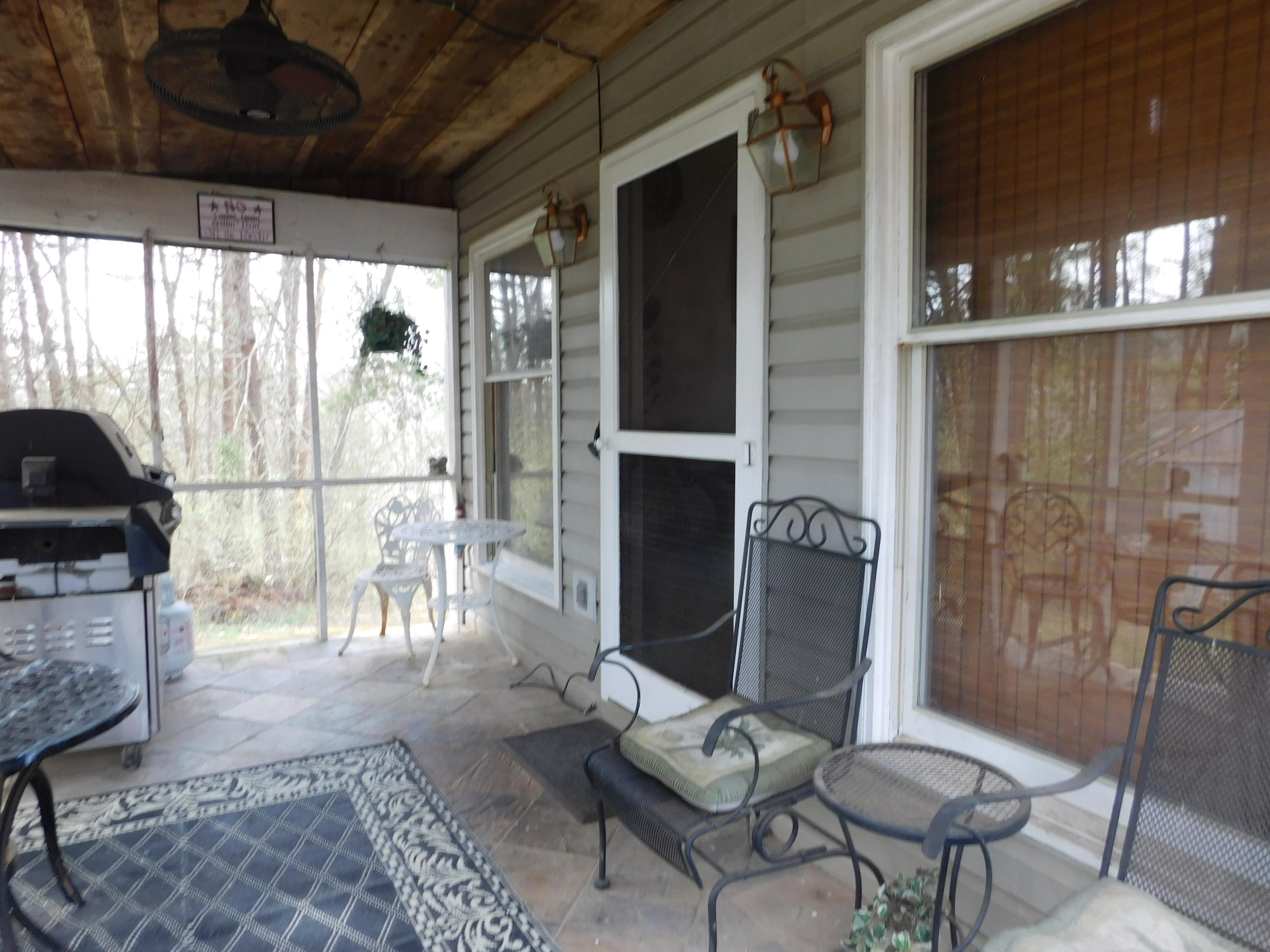 1463 Stripers Cove Road Goodview, VA 24095 - Photo 37 of 44 a living room with furniture a lamp and a potted plant
