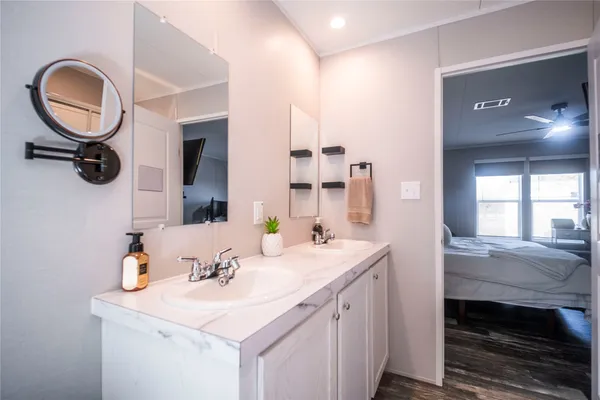 a bathroom with a sink double vanity and a mirror