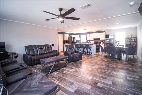 a living room with lots of furniture and a large window
