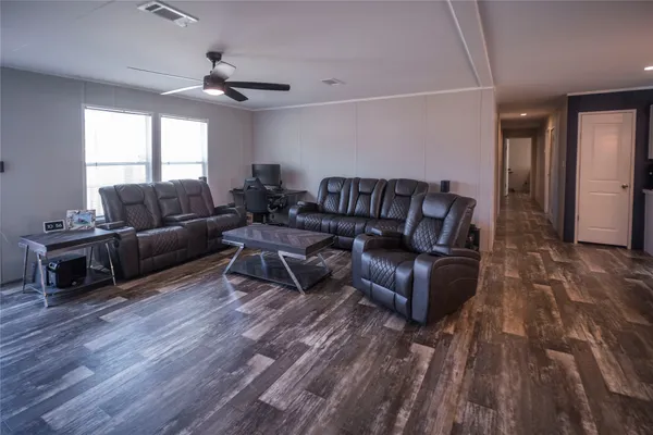 a living room with furniture and wooden floor