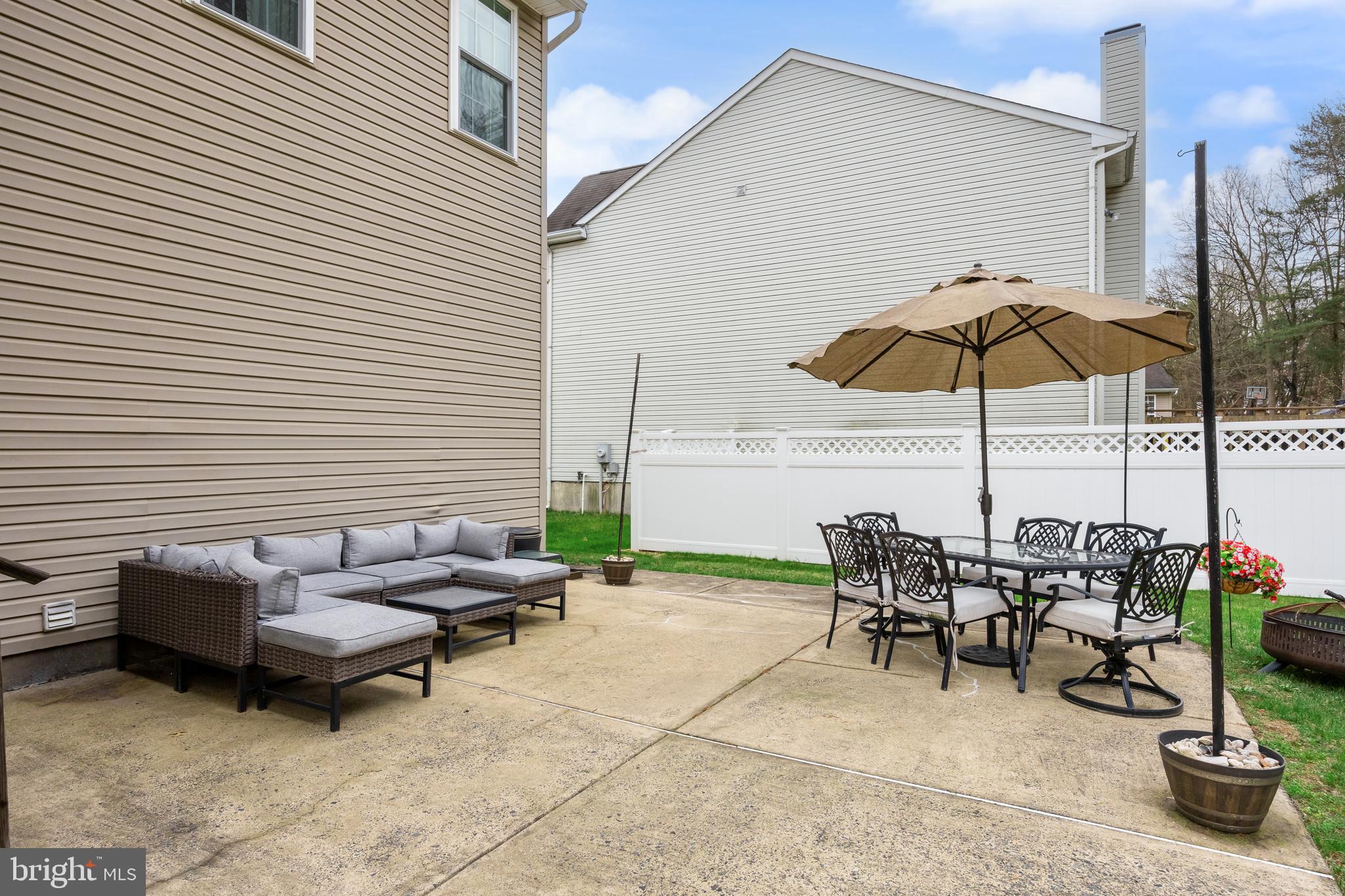 53 Cranberry Lane Delran, NJ 08075 - Photo 30 of 33 a view of a patio with chairs and table under an umbrella
