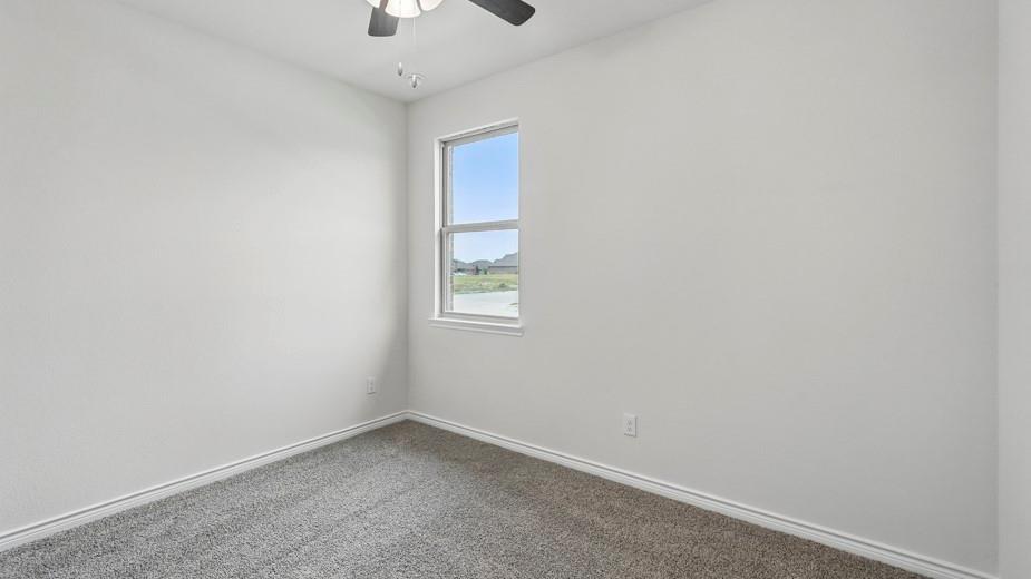 4162 Waldron Trail Forney, TX 75126 - Photo 27 of 29 Neutral-toned room featuring a single window, light gray carpet, and a ceiling fan