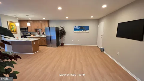 a view of a kitchen with a sink and a refrigerator