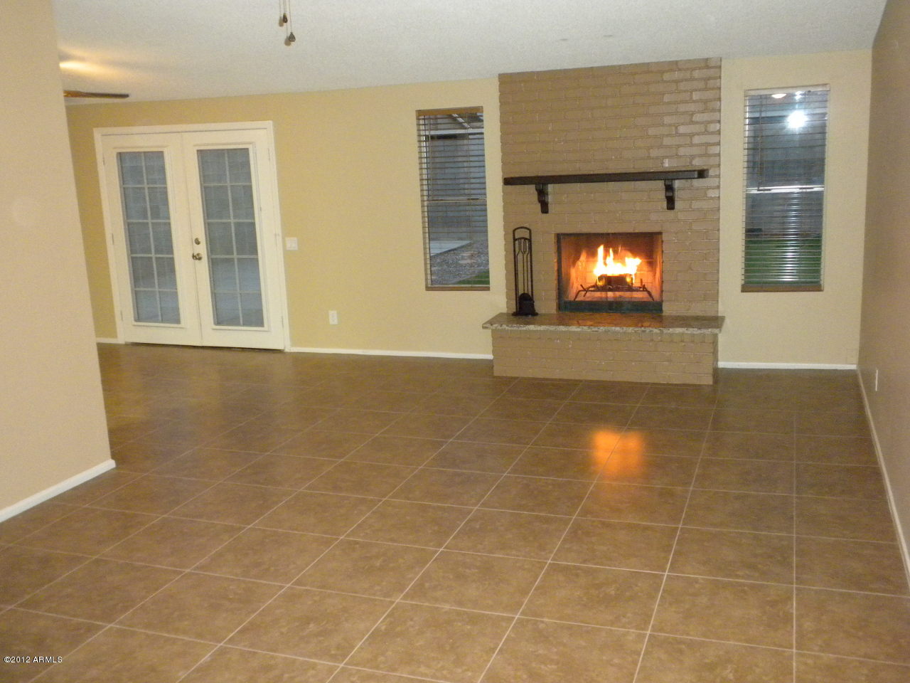1506 West Colt Road Chandler, AZ 85224 - Photo 2 of 27 an empty room with a fireplace and windows