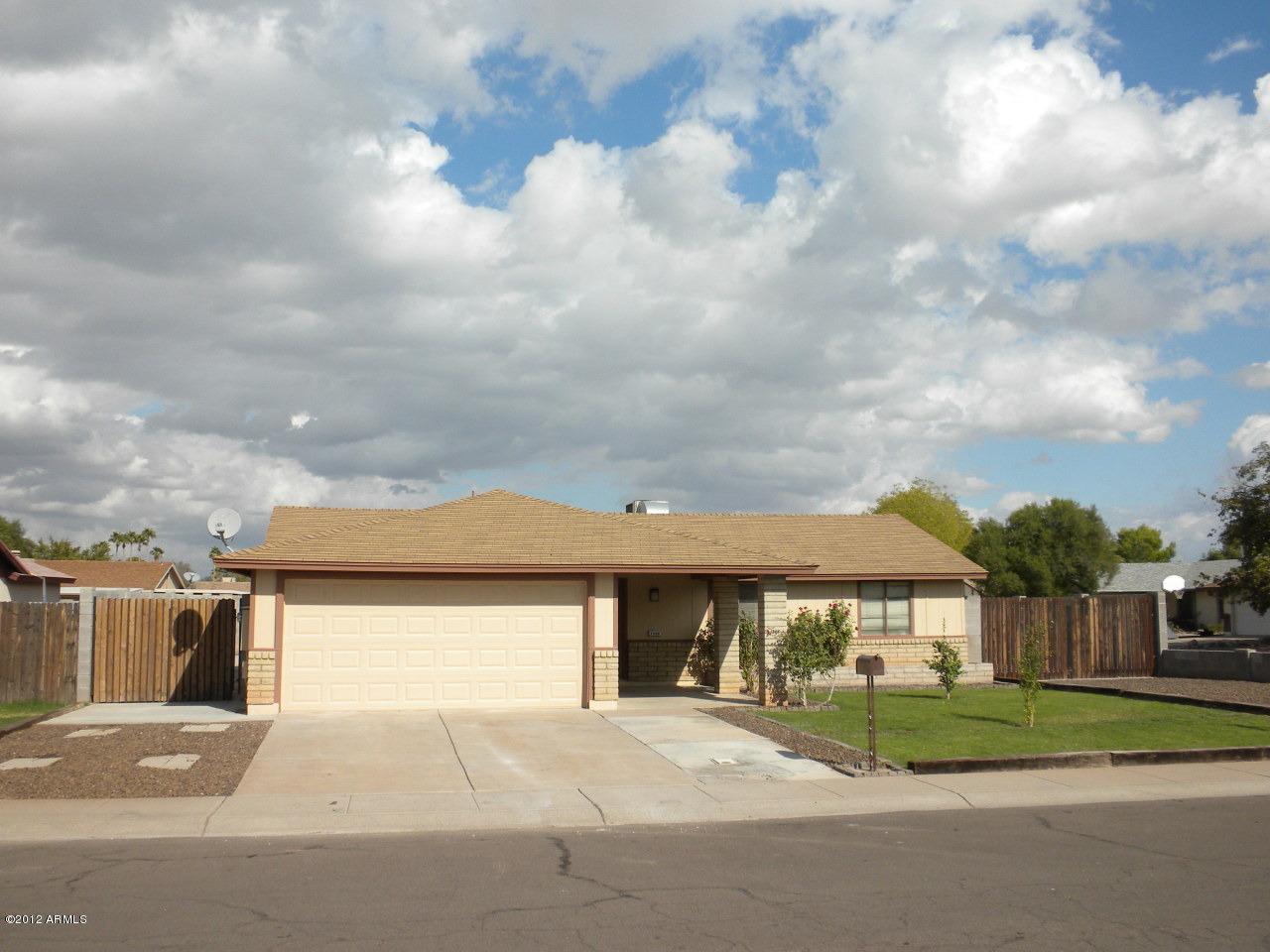 1506 West Colt Road Chandler, AZ 85224 - Photo 24 of 27 a front view of a house with a yard and garage