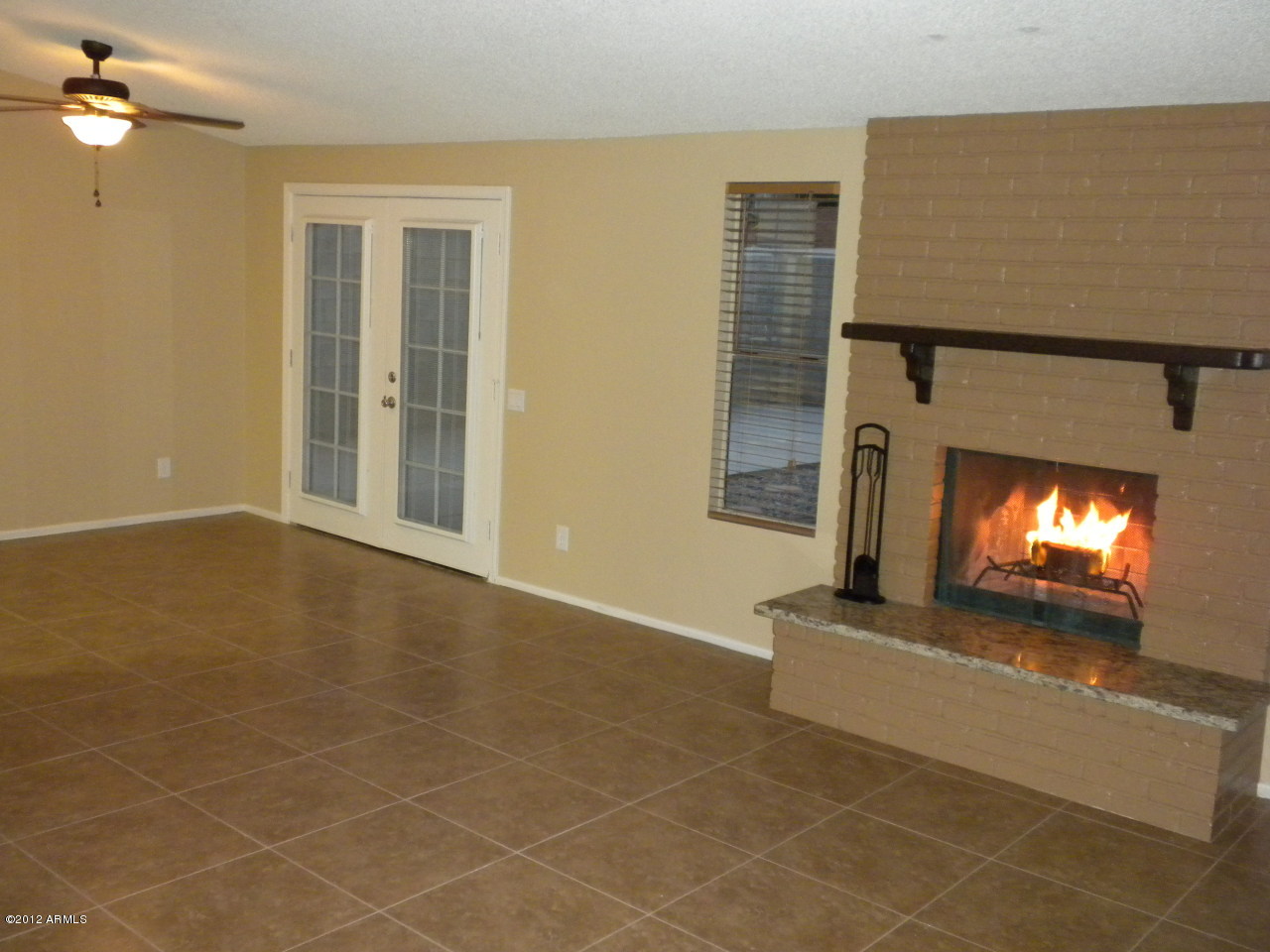 1506 West Colt Road Chandler, AZ 85224 - Photo 3 of 27 a view of an empty room with a fireplace and window