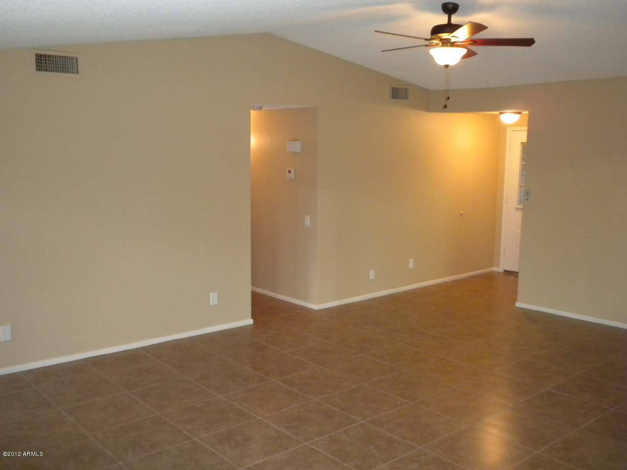 1506 West Colt Road Chandler, AZ 85224 - Photo 4 of 27 an empty room with a ceiling fan and window