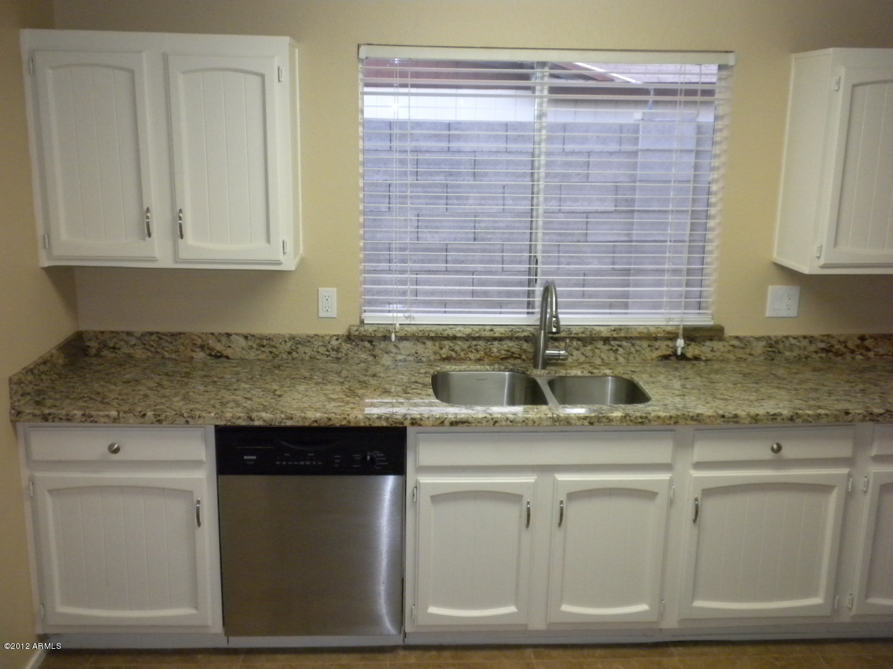 1506 West Colt Road Chandler, AZ 85224 - Photo 5 of 27 a kitchen with granite countertop white cabinets and a sink