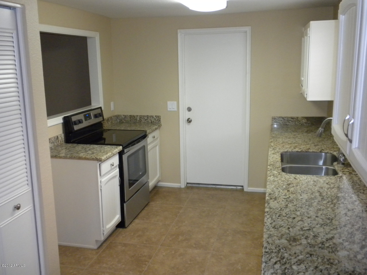 1506 West Colt Road Chandler, AZ 85224 - Photo 8 of 27 a kitchen with a stove and a granite counter tops