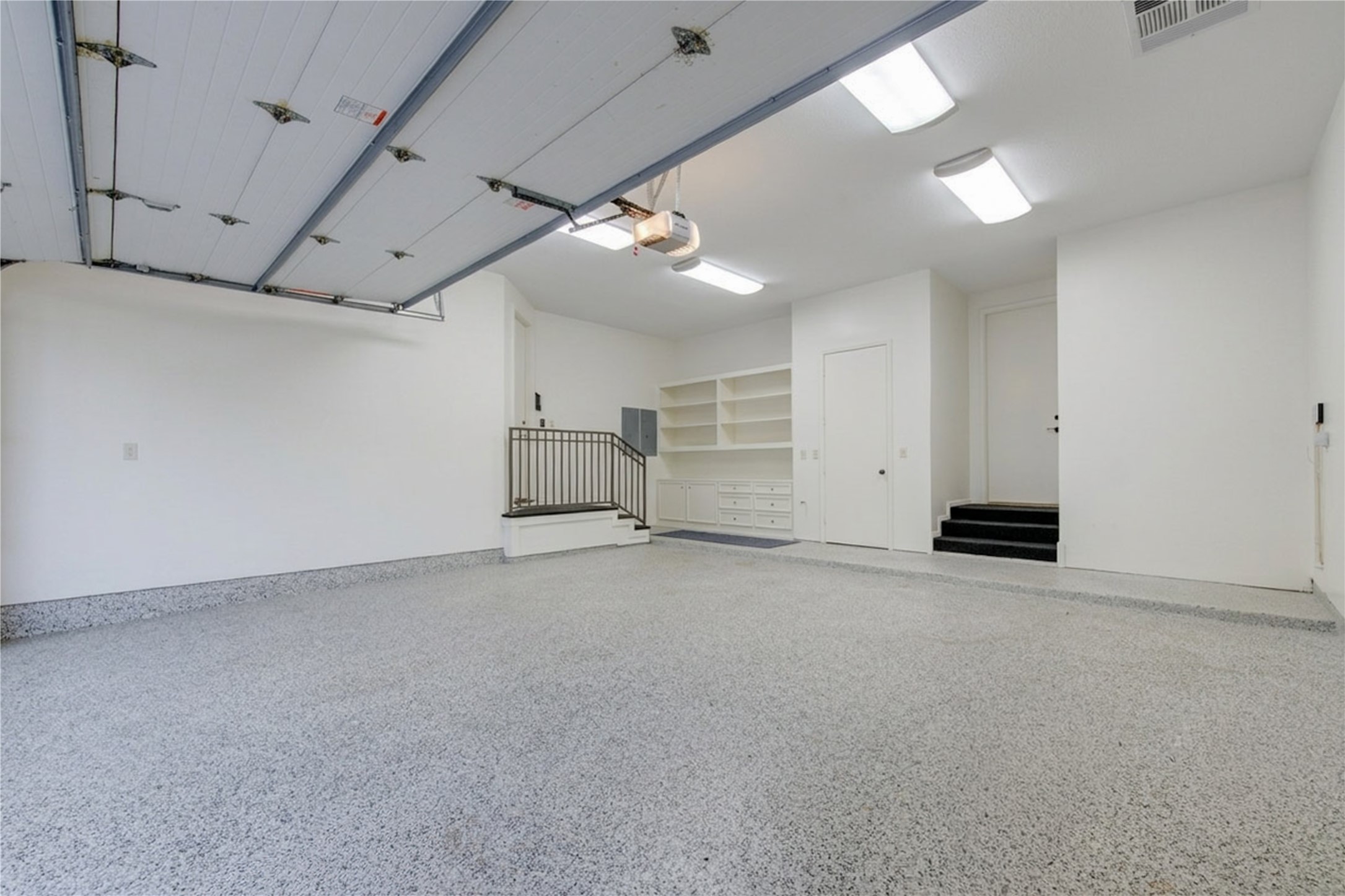 4615 Laurel Street Bellaire, TX 77401 - Photo 43 of 48 Awesome Garage with epoxy flooring, built-in cabinets, drawers and storage closet. Home water filtration system located in closet. 2 accesses into home.