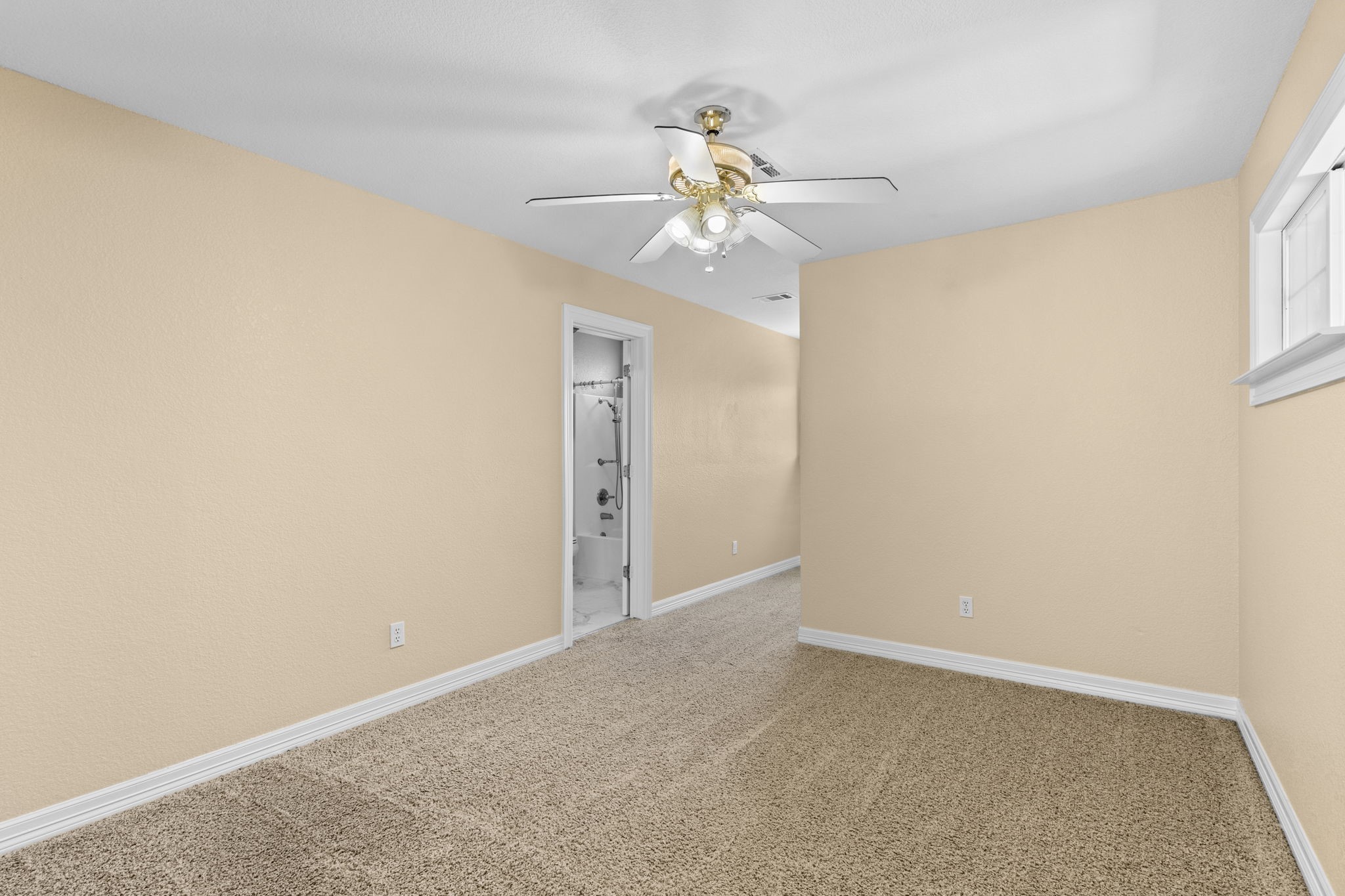 900 Southwind Port Arthur, TX 77640 - Photo 14 of 38 an empty room with a chandelier fan and windows