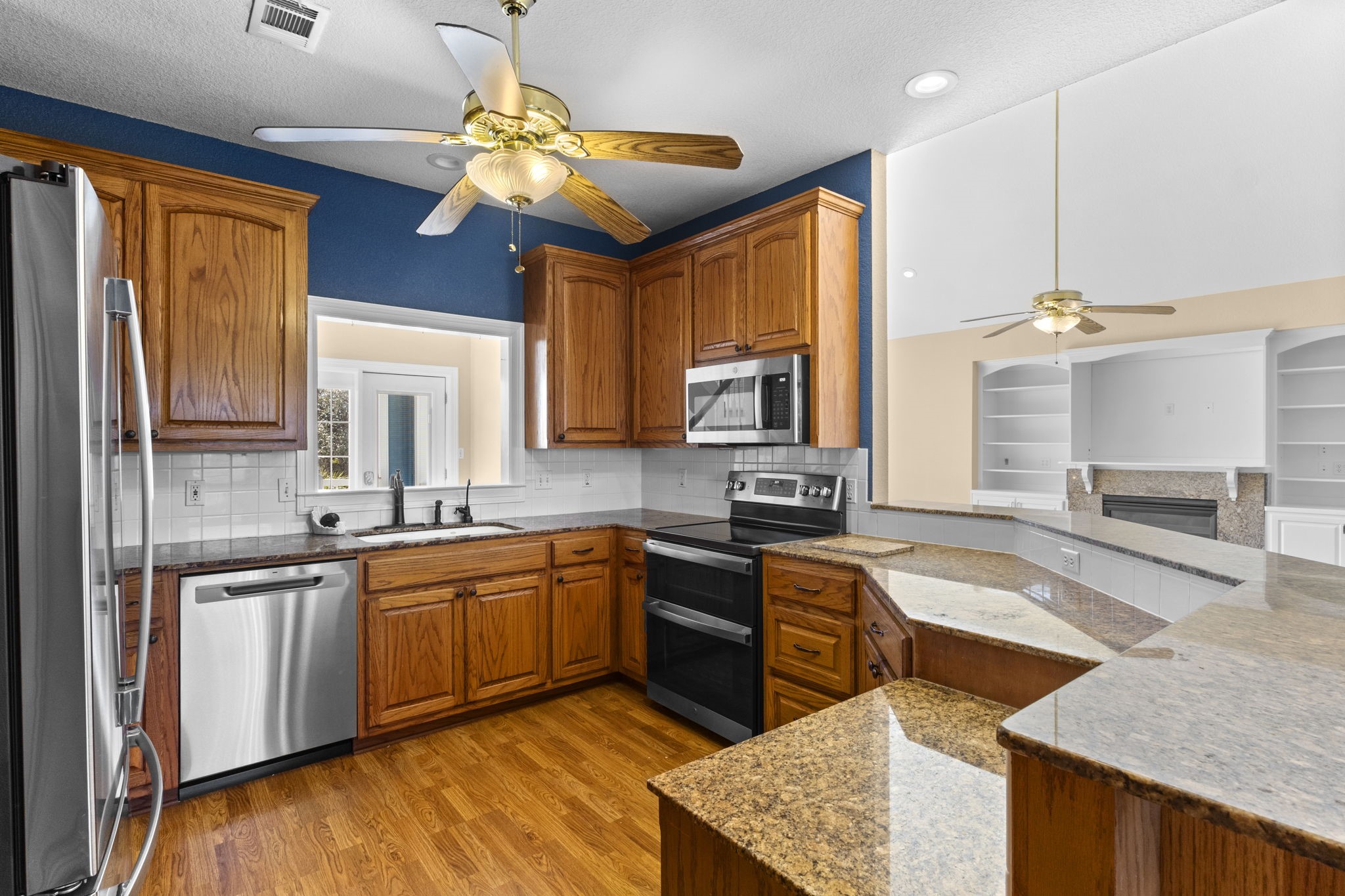 900 Southwind Port Arthur, TX 77640 - Photo 28 of 38 a kitchen with stainless steel appliances granite countertop sink stove top oven and cabinets