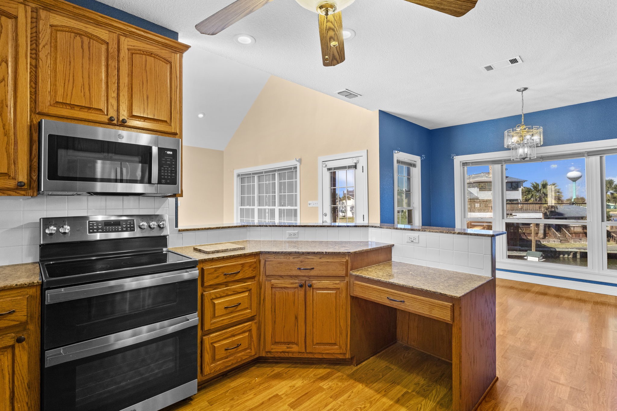 900 Southwind Port Arthur, TX 77640 - Photo 29 of 38 a kitchen with wooden cabinets and a stove top oven