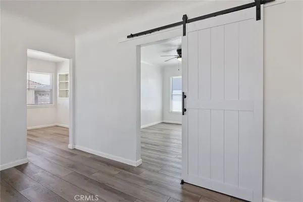 a kitchen with stainless steel appliances granite countertop a sink dishwasher a stove and a refrigerator with wooden floor