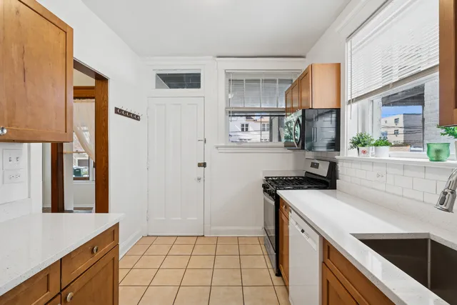 a kitchen with a sink a stove and cabinets