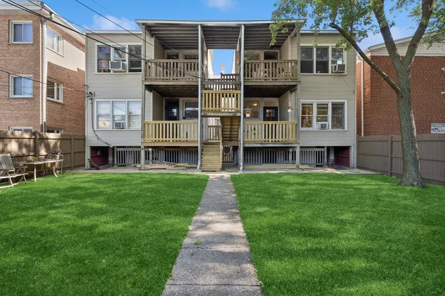 a brick building with a yard in front of it