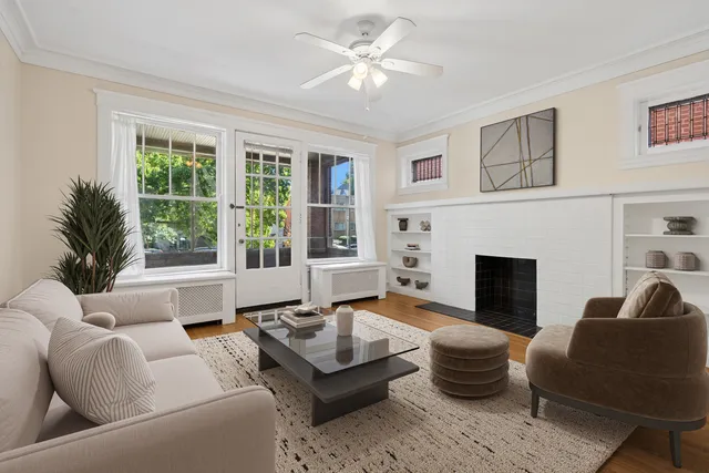a living room with furniture fireplace and window
