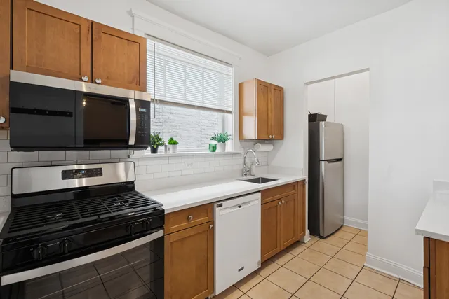 a kitchen with a sink stove and microwave